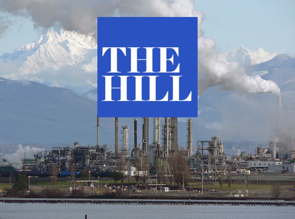 An oil refinery in Anacortes, WA with Mount Rainier in the background. The Hill logo is superimposed.