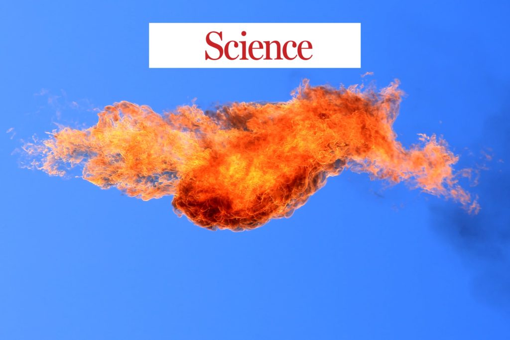A methane gas flare against a blue sky with the journal Science logo.