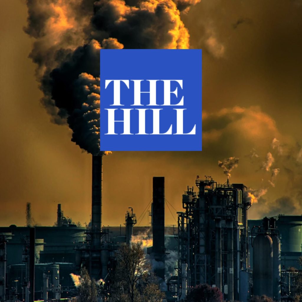 Smoke and steam billowing from and oil refinery smoke stack with The Hill logo superimposed.