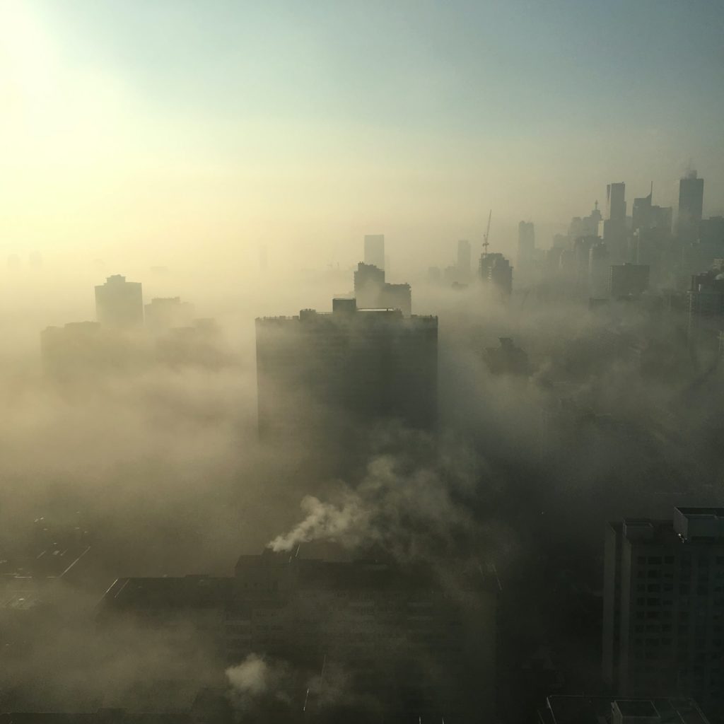 An aerial view of a polluted city.